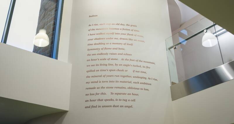 Melanie Challenger's poem Suilven installed on a tall wall at Highland Hospice