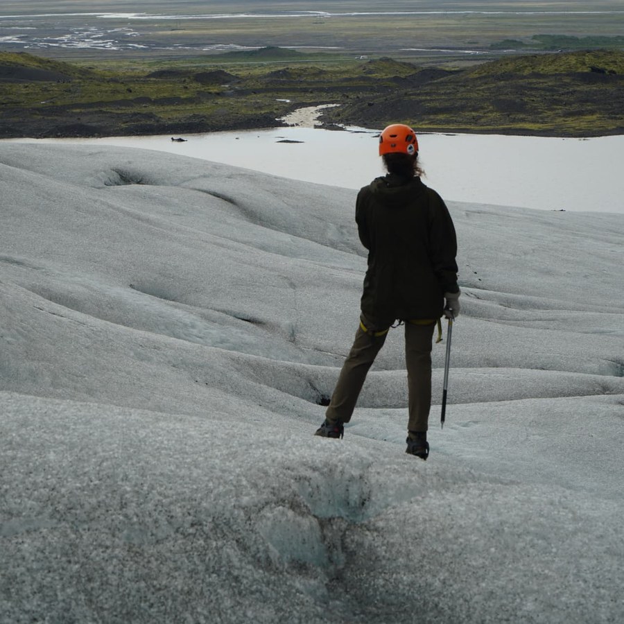 Melanie Challenger in mountaineering gear on a glacier in the far south.